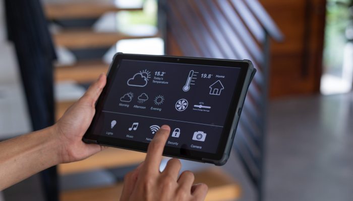 Hands of biracial man at home using tablet with smart home interface on screen. Communication, technology and domestic life concept. Hands of biracial man at home using tablet with smart home interface on screen. Communication, technology and domestic life concept.