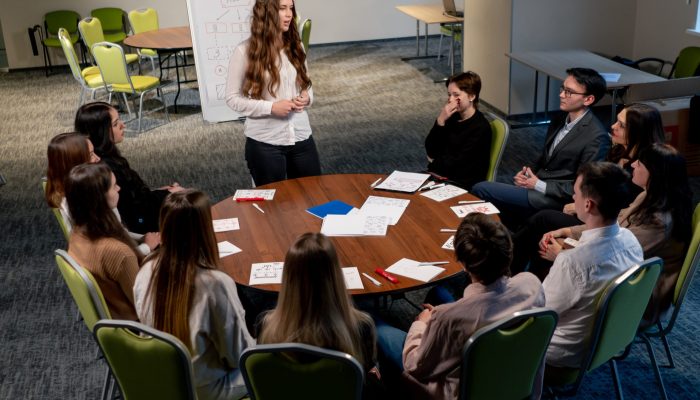 business conference or meeting at the hotel the girl on the flipchart shows the development plan for the company business conference or meeting at the hotel the girl on the flipchart shows the development plan for company